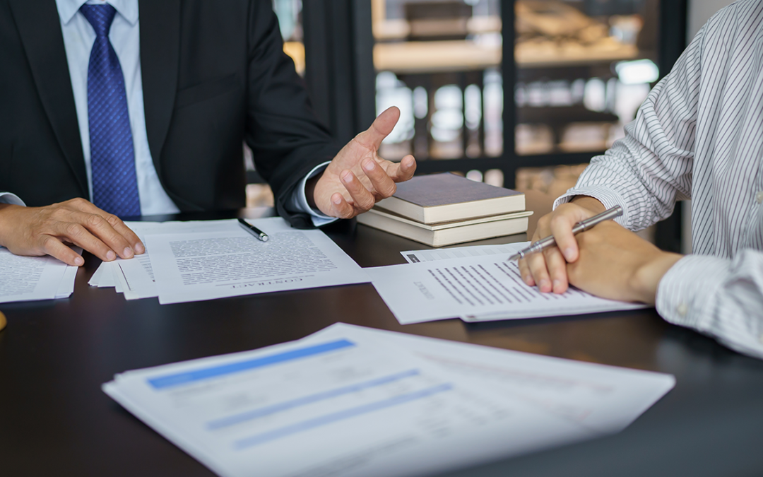 two people sitting at a table discussing government contract opportunites