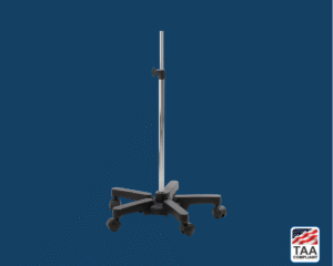 Black Riester mobile stand for BigBen sphygmomanometer, featuring chrome base with five wheels and height-adjustable column; positioned centrally on blue background with TAA Compliant box featuring American flag visible in lower right corner.