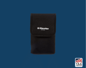 Riester e-scope pouch with black fabric body and zip closure, designed for portable storage of diagnostic equipment; positioned centrally on blue background with TAA Compliant box featuring American flag visible in lower right corner.