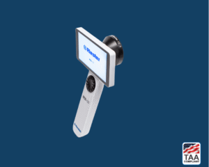 Derm lens attached to Riester RCS-100 dermatoscope in white, positioned in center on blue background; TAA Compliant box with American flag in lower right corner