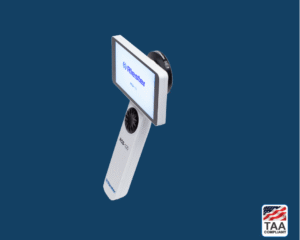 General imaging lens on Riester RCS-100 dermatoscope in white, positioned in center on blue background; TAA Compliant box with American flag in lower right corner