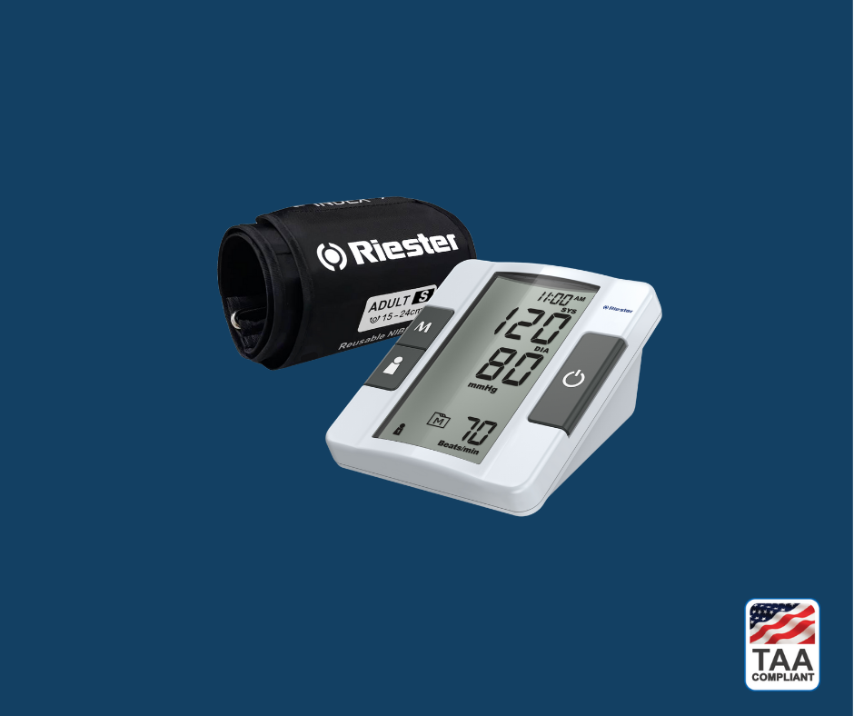 Riester ri-champion smartPRO blood pressure monitor with cuff connected and display screen active, shown angled to highlight operational interface and product readiness; positioned centrally on blue background with TAA Compliant box featuring American flag visible in lower right corner.