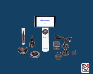 White RCS-100 diagnostic vitals device, with numerous attachments, displayed on blue background; TAA Compliant box with American flag in lower right corner