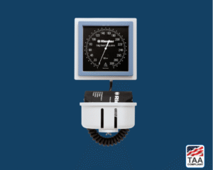 Black and silver Riester big ben Square Wall Design diagnostic device with pressure gauge and coiled tubing, displayed on blue background; TAA Compliant box with American flag in lower right corner