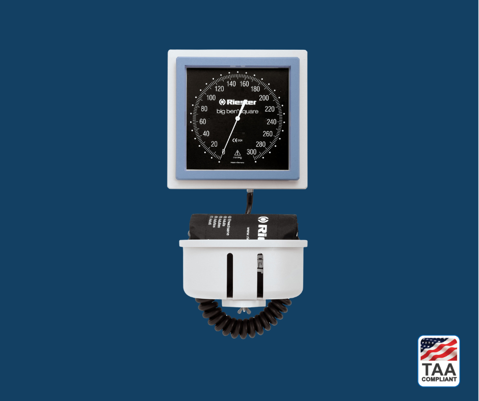 Black and silver Riester big ben Square Wall Design diagnostic device with pressure gauge and coiled tubing, displayed on blue background; TAA Compliant box with American flag in lower right corner