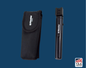 Black Riester e-xam otoscope with smooth grip, shown resting next to a black carrying pouch; positioned centrally on blue background with TAA Compliant box featuring American flag in lower right corner.