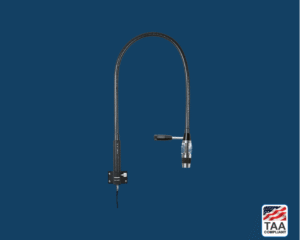 Riester ri-magic LED examination light with matte black body and silver clip attachment, positioned centrally on blue background; TAA Compliant box featuring American flag visible in lower right corner.